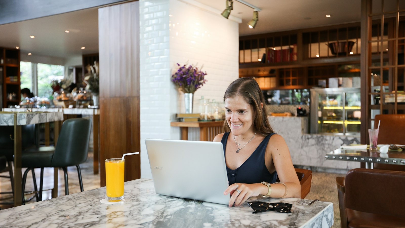 Restaurant manager reviewing the week's numbers on a laptop at the end of service